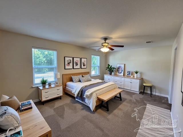 bedroom with visible vents, baseboards, ceiling fan, and dark colored carpet