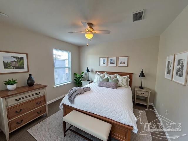 bedroom featuring baseboards, ceiling fan, dark colored carpet, and visible vents