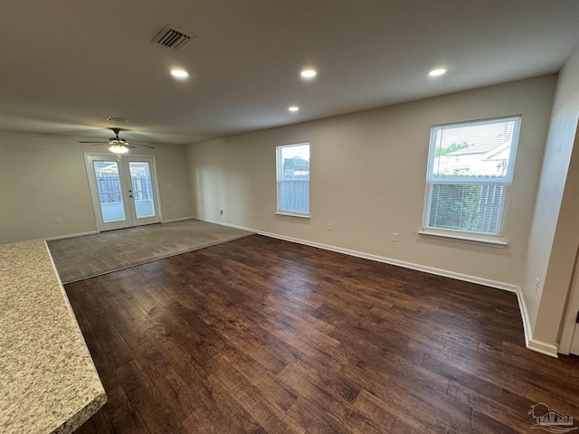 spare room featuring recessed lighting, visible vents, and dark wood-style floors