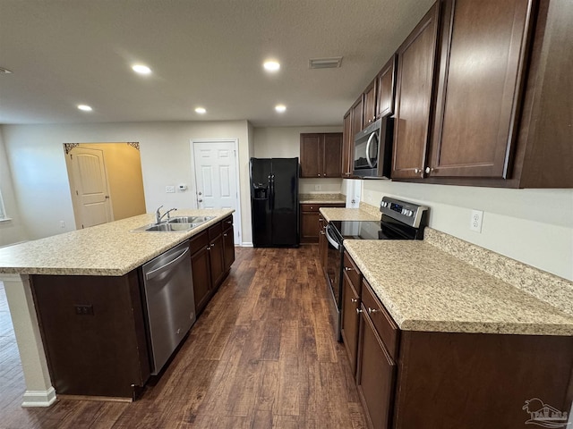 kitchen with dark wood-style flooring, visible vents, dark brown cabinets, a sink, and stainless steel appliances