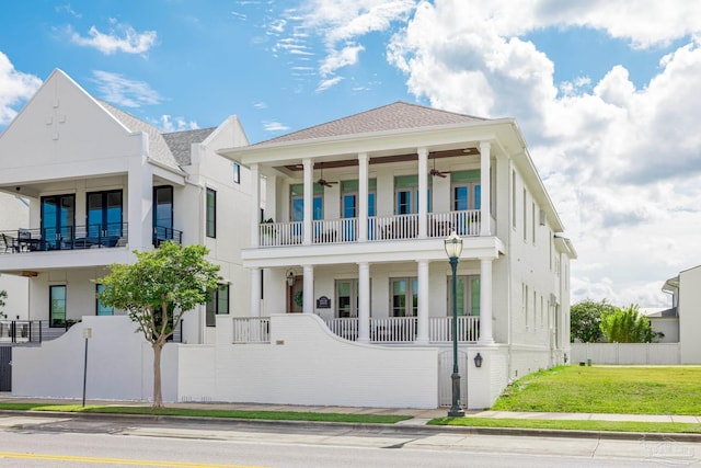 view of front of property with a balcony and a front lawn