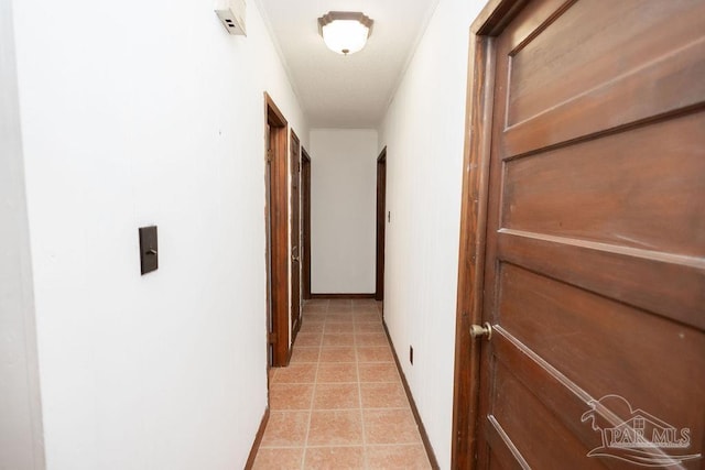 corridor with light tile patterned floors