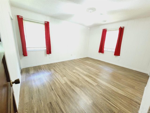 unfurnished room featuring light hardwood / wood-style floors