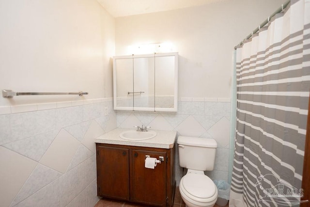 bathroom featuring vanity, tile walls, curtained shower, and toilet