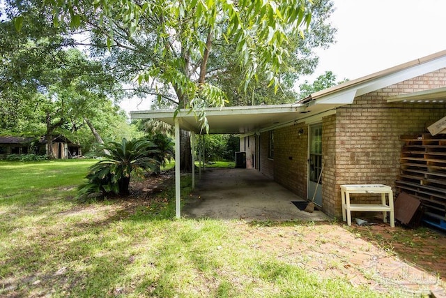 view of parking with a carport and a lawn