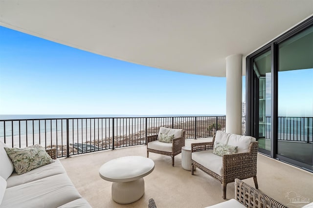 balcony with a beach view, outdoor lounge area, and a water view