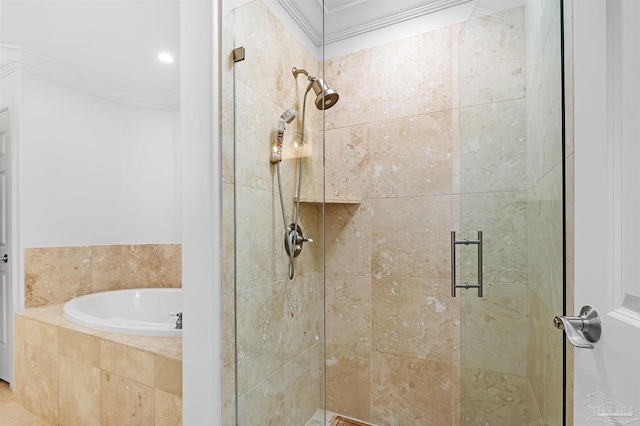 bathroom with crown molding, a garden tub, and a shower stall