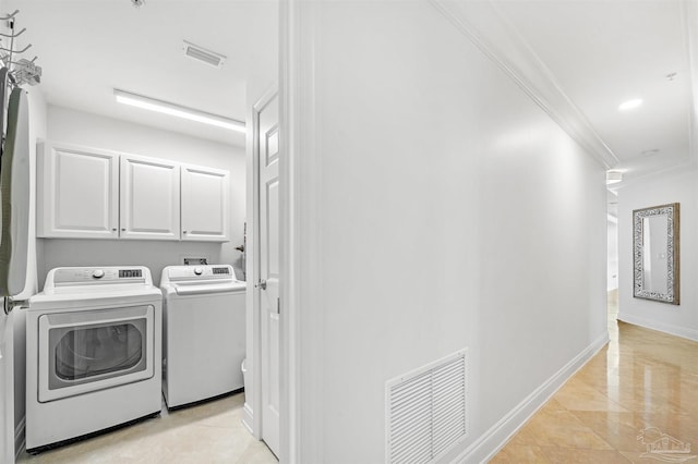 laundry area with cabinet space, independent washer and dryer, baseboards, visible vents, and crown molding