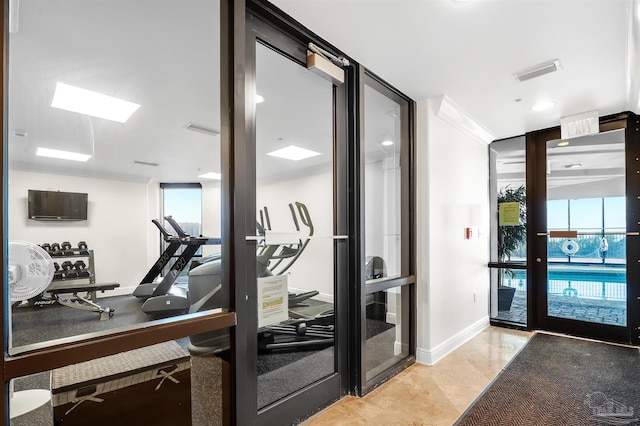 gym with baseboards and visible vents