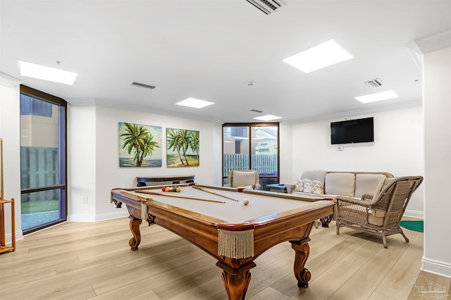 recreation room with baseboards, a wall of windows, light wood-style floors, and visible vents