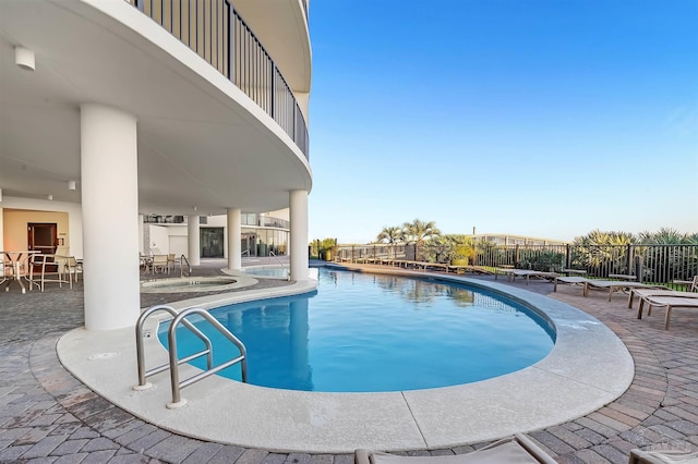 pool featuring a patio area and fence