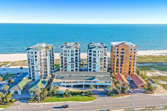 drone / aerial view featuring a water view and a view of the beach