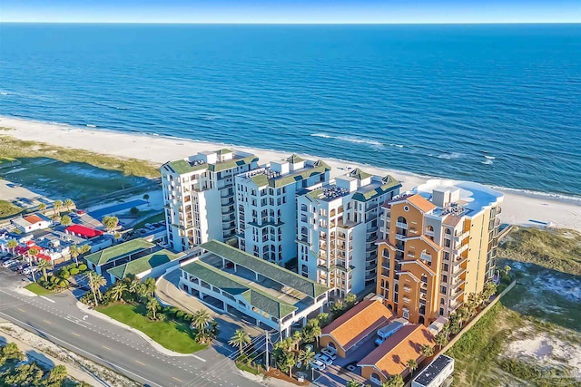 drone / aerial view featuring a water view and a view of the beach