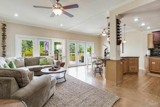 living room with ornamental molding, french doors, ceiling fan, and light hardwood / wood-style flooring