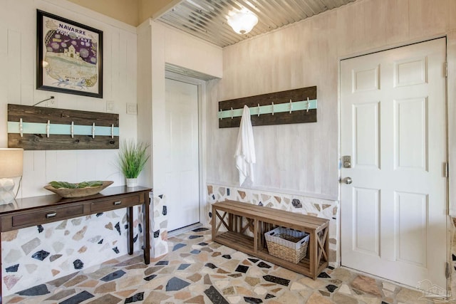 mudroom featuring wood walls and wood ceiling