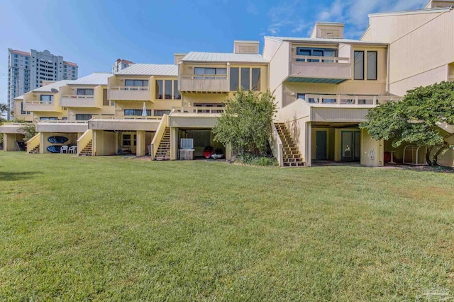 rear view of property featuring a lawn