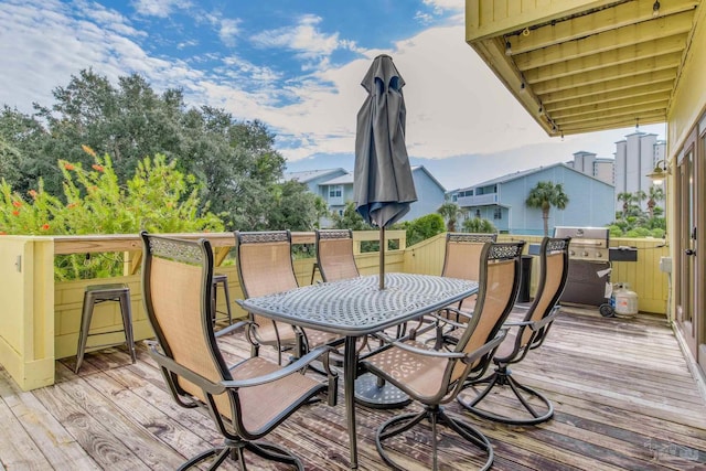 wooden deck with a grill