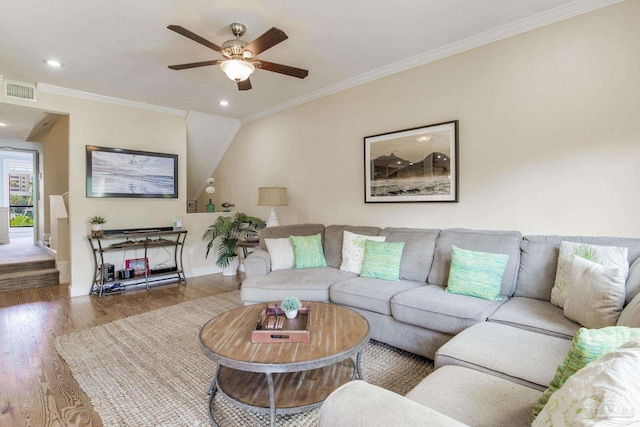 living room with hardwood / wood-style floors, ceiling fan, and ornamental molding