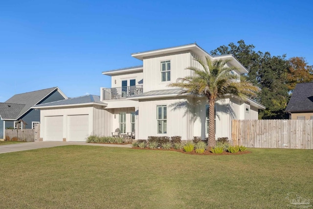 view of front of property with a balcony, a front lawn, and a garage