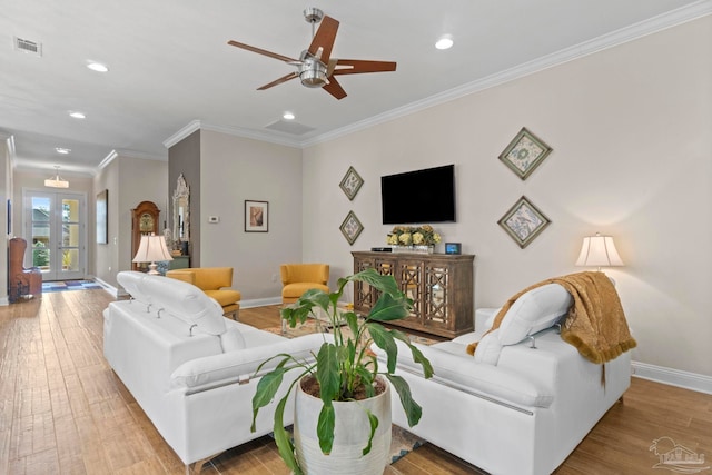 living area with recessed lighting, wood finished floors, visible vents, baseboards, and ornamental molding