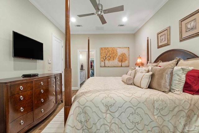 bedroom featuring visible vents, ornamental molding, and wood finished floors