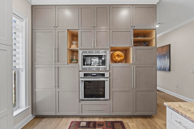 kitchen featuring open shelves, light wood-style flooring, stainless steel appliances, and gray cabinetry