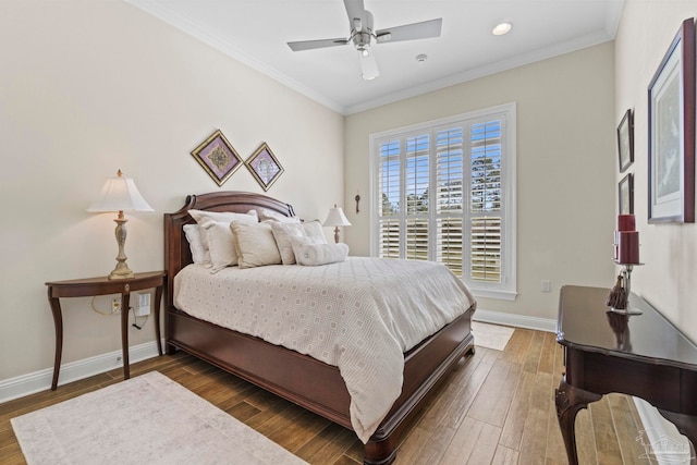 bedroom featuring baseboards, wood finished floors, and crown molding