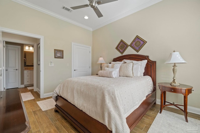 bedroom featuring ornamental molding, light wood-type flooring, visible vents, and baseboards