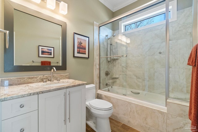 full bath with toilet, vanity, tiled shower / bath, and ornamental molding