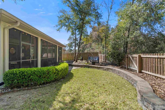 view of yard with a fenced backyard and a sunroom