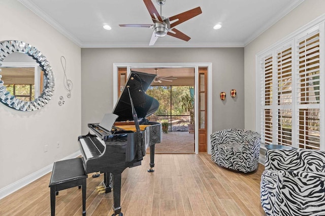 living area featuring recessed lighting, wood finished floors, a ceiling fan, baseboards, and ornamental molding