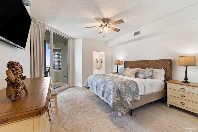 tiled bedroom with ceiling fan and a textured ceiling