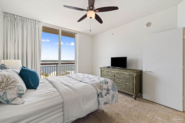 tiled bedroom featuring a textured ceiling, access to exterior, and ceiling fan