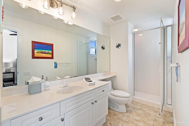 bathroom featuring a shower with door, vanity, a textured ceiling, toilet, and tile patterned floors