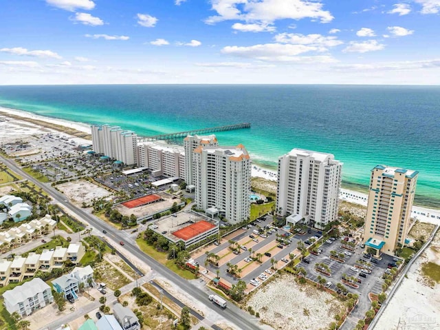 birds eye view of property featuring a water view and a beach view