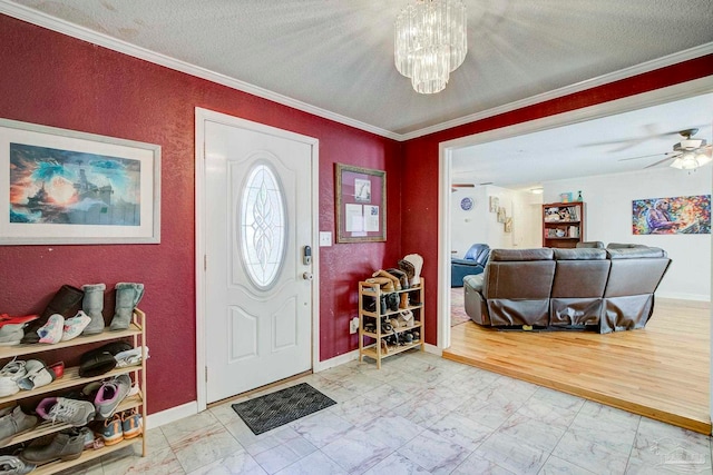 14574 N County Rd 65, Foley, AL 36535 - entryway featuring marble finish floors, a chandelier, ornamental molding, baseboards, and a textured wall