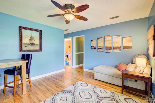 14574 N County Rd 65, Foley, AL 36535 - living room featuring wood finished floors, a ceiling fan, and baseboards