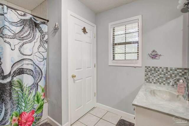 14574 N County Rd 65, Foley, AL 36535 - bathroom with vanity, tile patterned floors, baseboards, a shower with curtain, and a textured ceiling