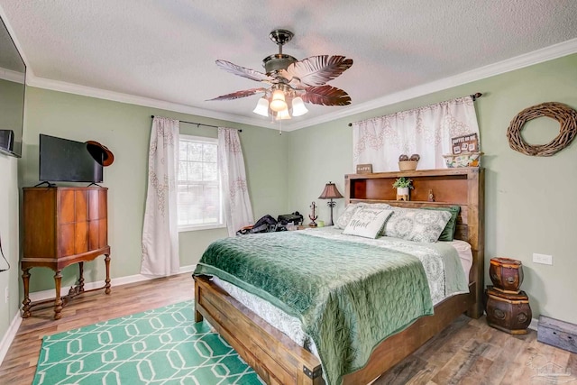 14574 N County Rd 65, Foley, AL 36535 - bedroom with crown molding, wood finished floors, a textured ceiling, ceiling fan, and baseboards