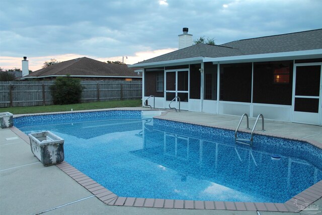 view of swimming pool with a sunroom