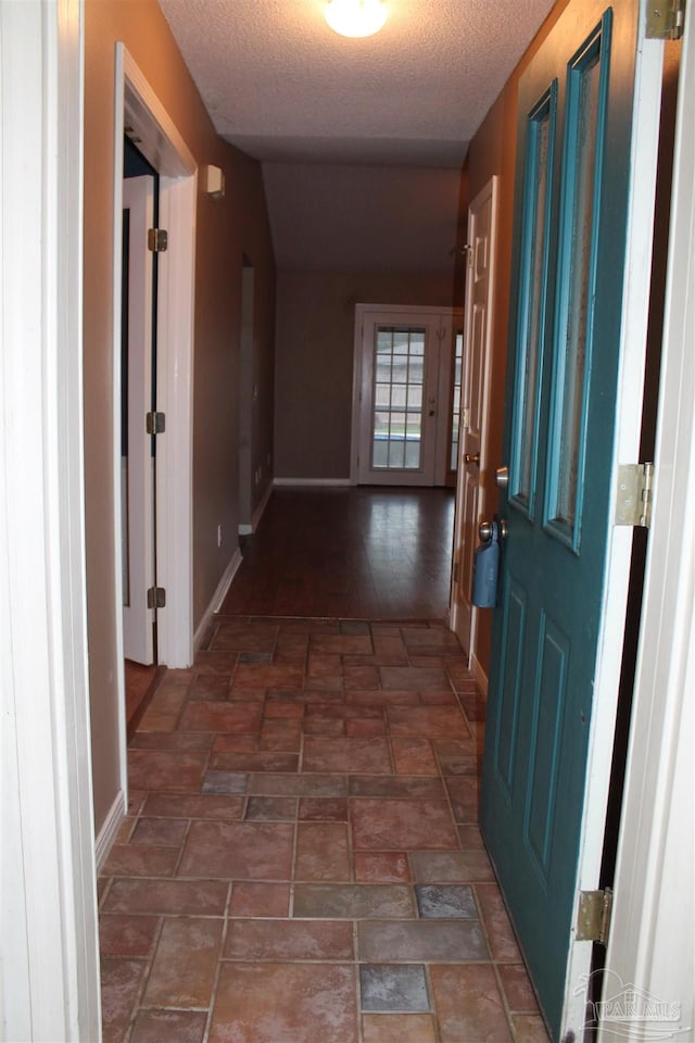 hallway featuring a textured ceiling