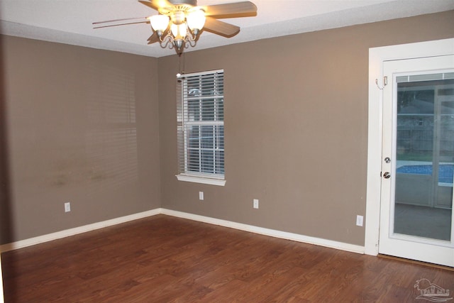 spare room featuring ceiling fan and dark hardwood / wood-style floors