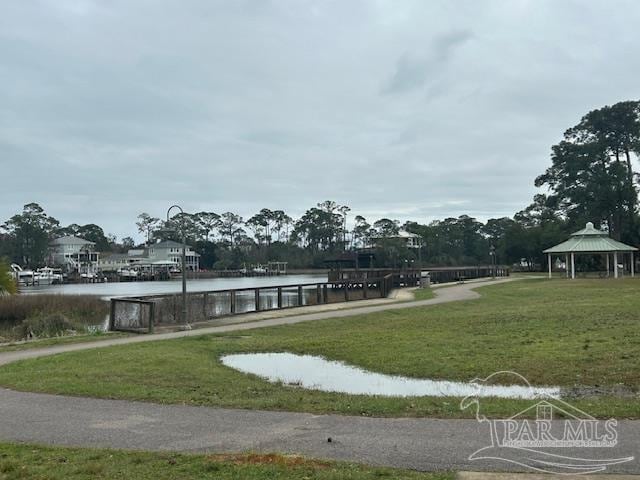 view of home's community featuring a water view, a lawn, and a gazebo