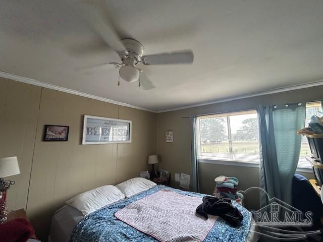 bedroom with a ceiling fan and crown molding