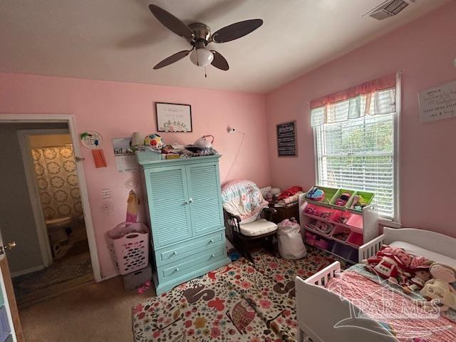 bedroom with carpet, visible vents, and ceiling fan