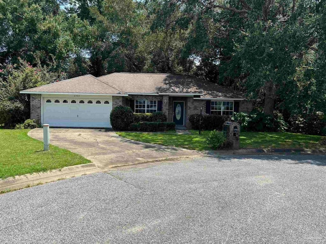 ranch-style house with a garage and a front lawn