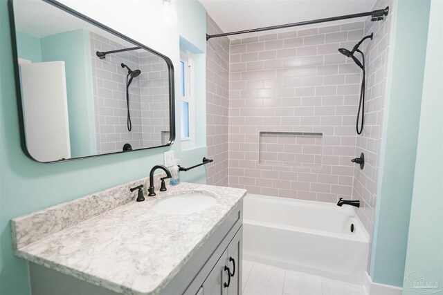 bathroom featuring vanity, tiled shower / bath combo, and tile patterned floors