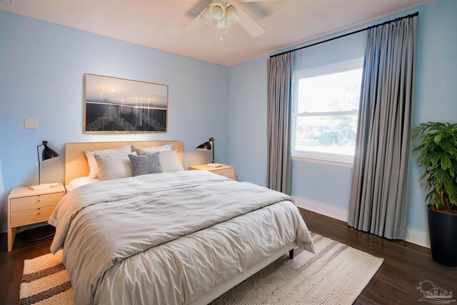 bedroom with ceiling fan and dark hardwood / wood-style floors