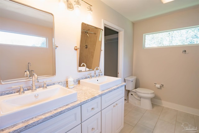 bathroom with a shower with curtain, vanity, plenty of natural light, and toilet