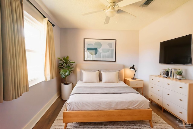 bedroom with ceiling fan and dark hardwood / wood-style floors